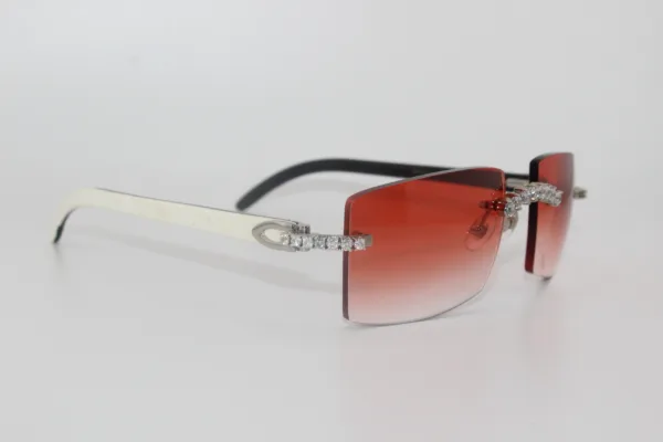 Custom handcrafted iced out buffalo horn sunglasses featuring premium white genuine horn temples, VVS1 moissanite corner accents, and an iced out nose bridge with 58mm red tint gradient lenses - one-of-a-kind luxury eyewear made in Michigan