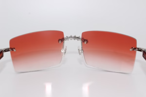 Custom handcrafted iced out buffalo horn sunglasses featuring premium white genuine horn temples, VVS1 moissanite corner accents, and an iced out nose bridge with 58mm red tint gradient lenses - one-of-a-kind luxury eyewear made in Michigan