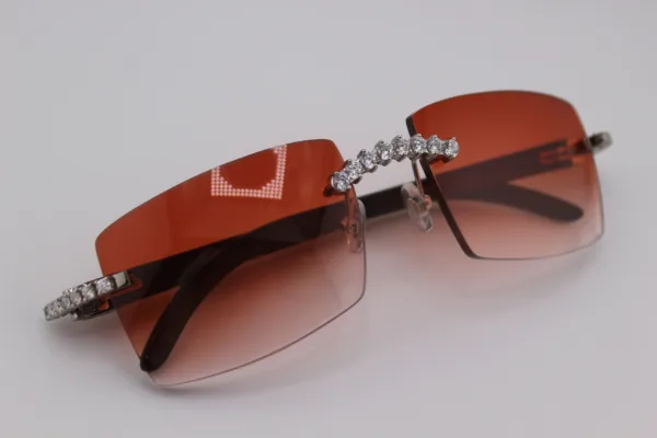 Custom handcrafted iced out buffalo horn sunglasses featuring premium white genuine horn temples, VVS1 moissanite corner accents, and an iced out nose bridge with 58mm red tint gradient lenses - one-of-a-kind luxury eyewear made in Michigan