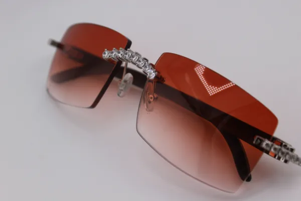 Custom handcrafted iced out buffalo horn sunglasses featuring premium white genuine horn temples, VVS1 moissanite corner accents, and an iced out nose bridge with 58mm red tint gradient lenses - one-of-a-kind luxury eyewear made in Michigan