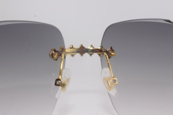 Handcrafted buffalo horn sunglasses featuring 2.2 carat VVS1 moissanite stones in low-profile prong setting on nose bridge, black genuine horn temples, and 58mm grey tint diamond cut lenses - one-of-a-kind functional face art made in Michigan