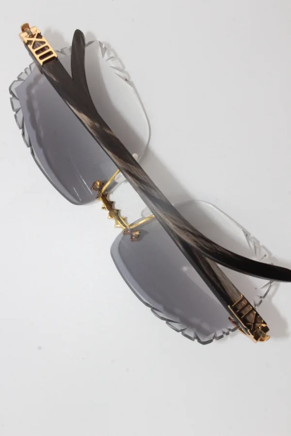 Handcrafted buffalo horn sunglasses featuring 2.2 carat VVS1 moissanite stones in low-profile prong setting on nose bridge, black genuine horn temples, and 58mm grey tint diamond cut lenses - one-of-a-kind functional face art made in Michigan